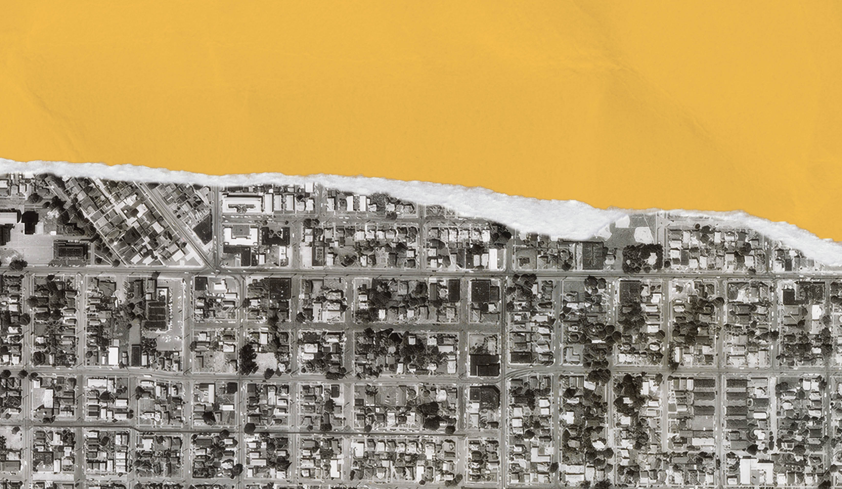 A black-and-white aerial photo of Portland with a torn edge indicating the planned route of the canceled Mount Hood Freeway