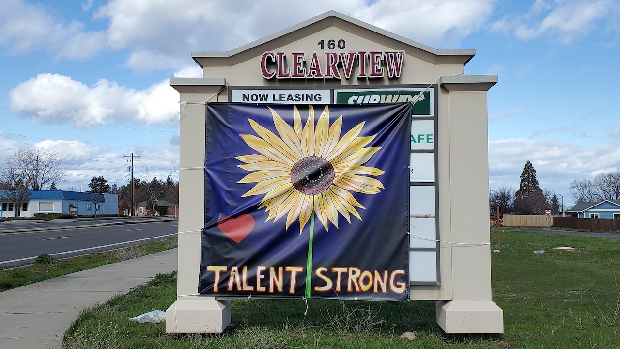 Photo: A banner featuring a sunflower and the words "Talent Strong" is draped over the signboard of a shopping center