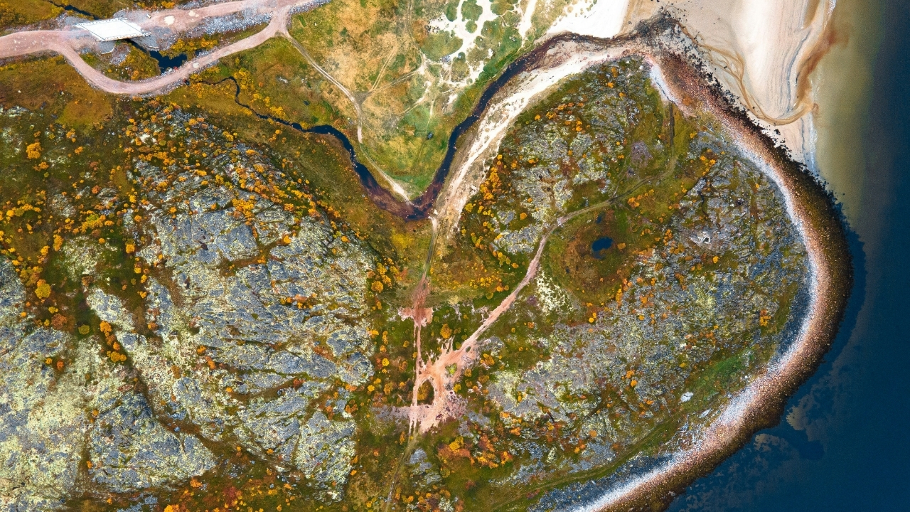 Aerial photograph of a river and land in Teriberka, Russia, by Dmitry Grachyov