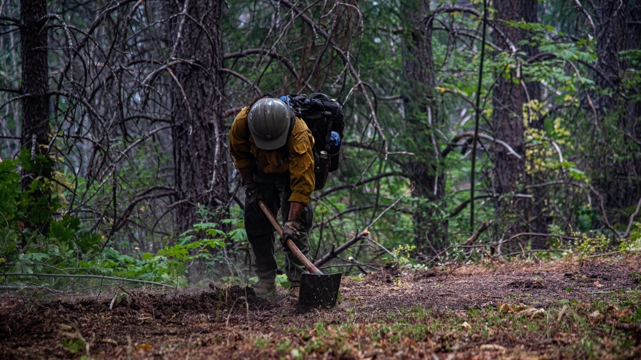 A firefighter digging line during the Slater fire in September 2020. Photo by U.S. Forest Service.