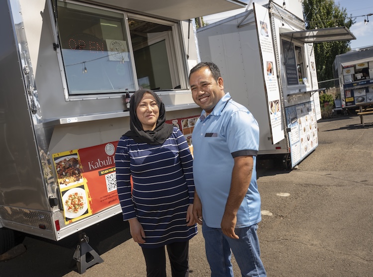 Reza and Kubra Mohammadi standing in front of their food truck, Kabuli Flavor.